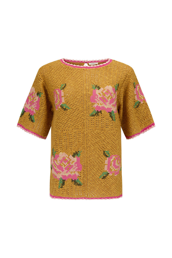Coastal Granny Top flat lay, mustard crochet knit with pink cross-stitch rose embroidery and pink scallop trim