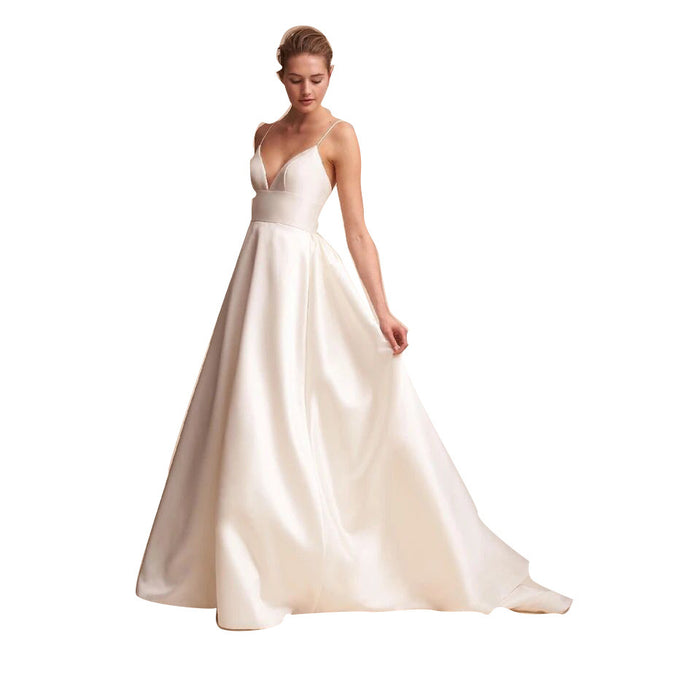 Elegant white slip wedding dress with a deep V-neckline and flowing skirt for a classic bridal look
