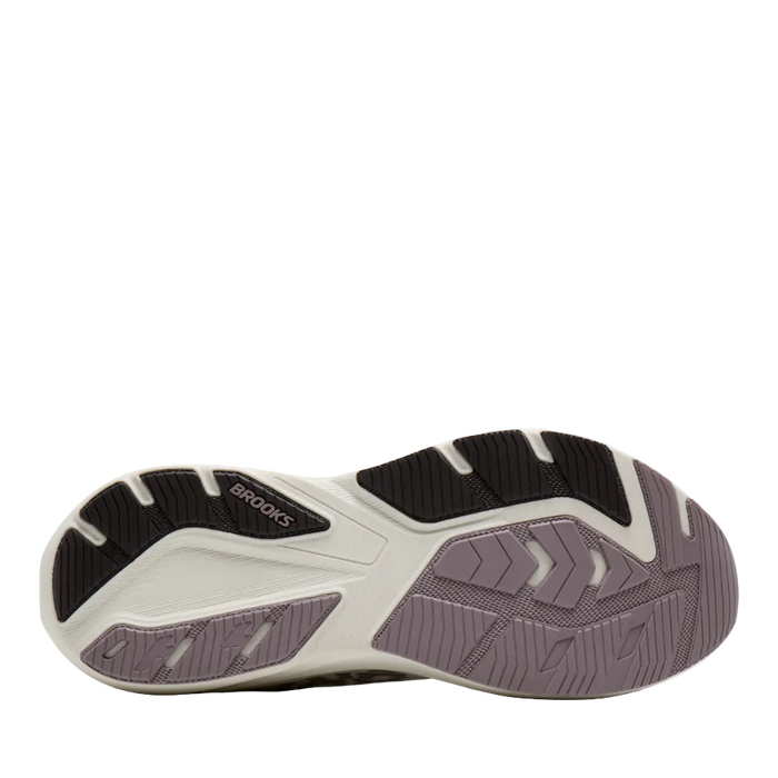 A close-up of a Brooks running shoe's outsole, showing a color-blocked design in black, off-white, and muted lavender-gray.