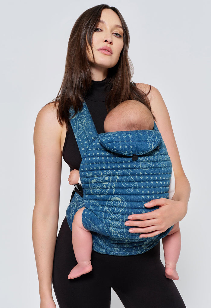 Front view of Armadillo Baby Carrier in Vintage Blue paisley cotton with padded crossover straps and side buckles