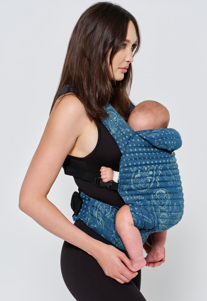 Side view of Bumpsuit x Spell Armadillo Baby Carrier in Vintage Blue with paisley print and padded cross-back straps