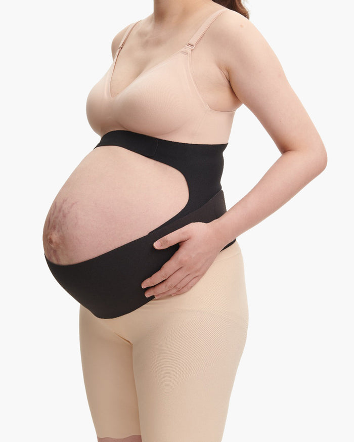 Black Momcozy BumpEase maternity band on pregnant person, showing ergonomic support fit.