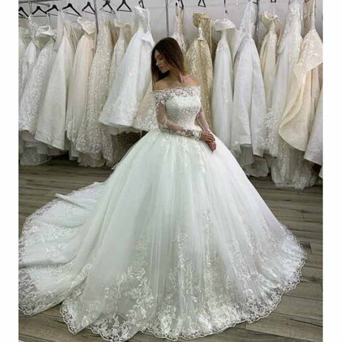 Elegant lace beach wedding dress with sleeves, featuring a flowy tulle skirt and off-the-shoulder design