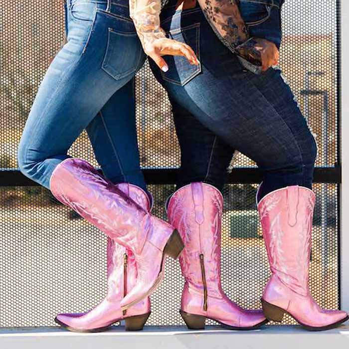 Stylish metallic cowgirl boots for women in pink paired with denim jeans, perfect for a fashionable look