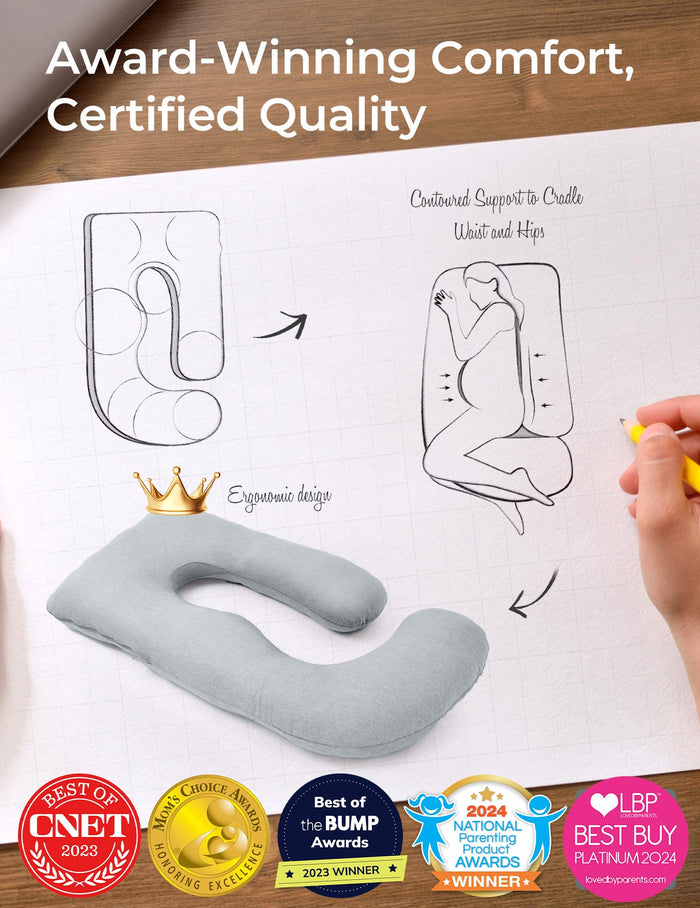 Light grey U-shaped maternity pillow, ergonomic design, supports pregnant women. Award-winning comfort.