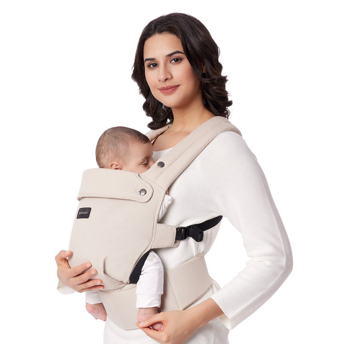 Momcozy PureHug baby carrier in beige with mother and baby. Comfortable and supportive design for babywearing.