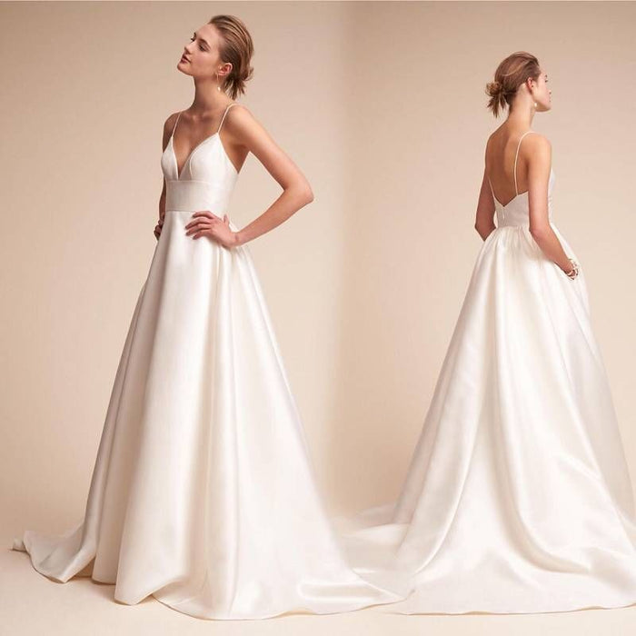 Elegant white slip wedding dress with a simple design and backless detail for a timeless bridal look