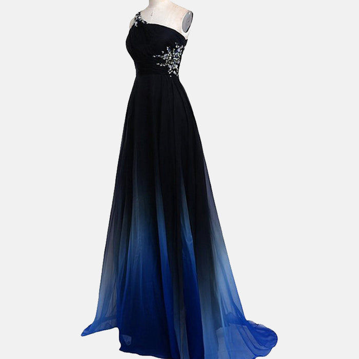 Elegant one shoulder ombre prom dress with black to blue gradient and floral embellishments