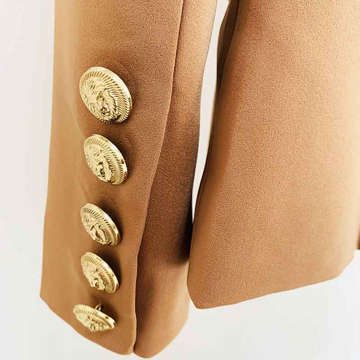 Close-up of women's camel pantsuit for work featuring gold button details on the sleeves