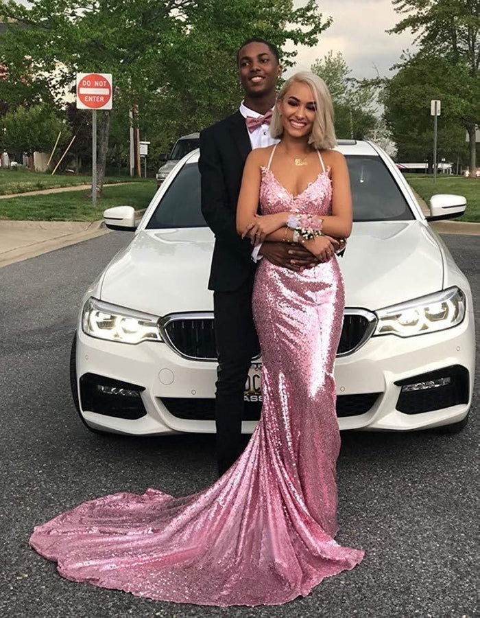 Elegant mermaid sequin prom dress in pink worn at a photoshoot with a couple by a car