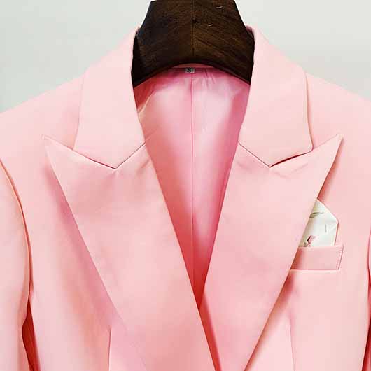 Close-up of a pink blazer pantsuit for women featuring elegant lapels and a stylish pocket square