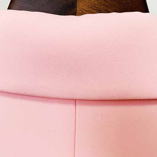 Close-up of the collar on a pink blazer pantsuit for women with a smooth finish