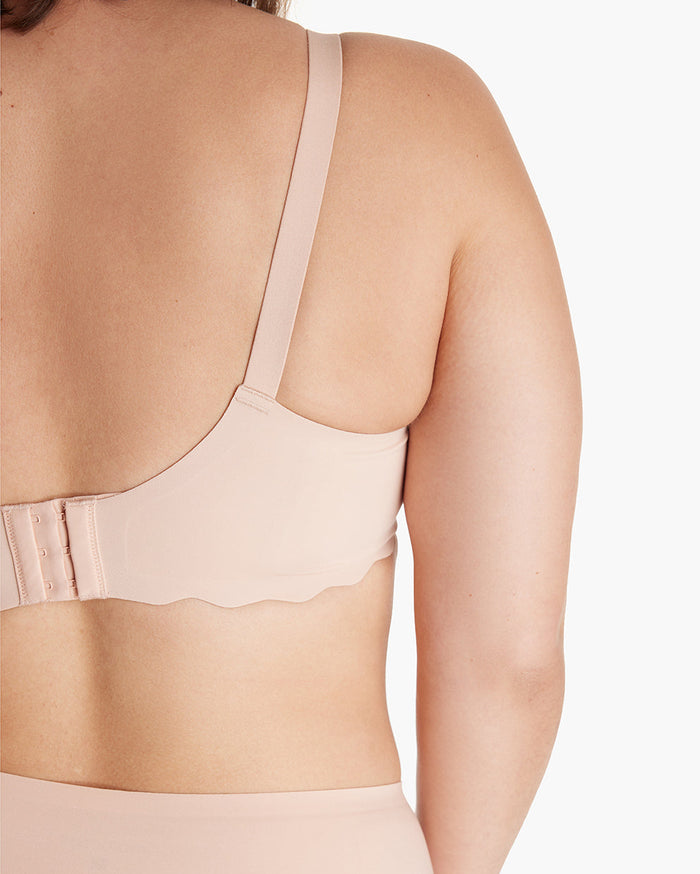 Woman models beige Jelly Strip Seamless Nursing Bra YN46, showing adjustable hook-and-eye & scalloped band for M9 Pump.