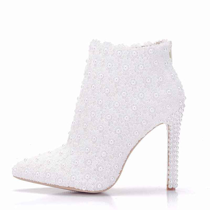 Stylish women's white wedding ankle boots adorned with pearls and a sleek stiletto heel