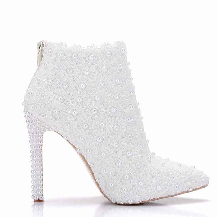 Elegant women's white wedding ankle boots adorned with pearl embellishments for a stylish bridal look