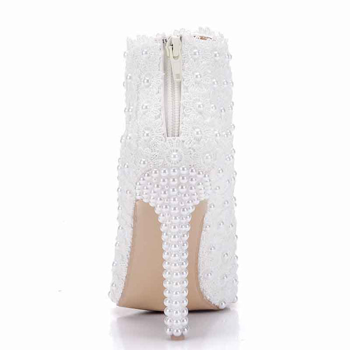 Stylish women's white wedding ankle boots adorned with pearl embellishments and a zipper closure