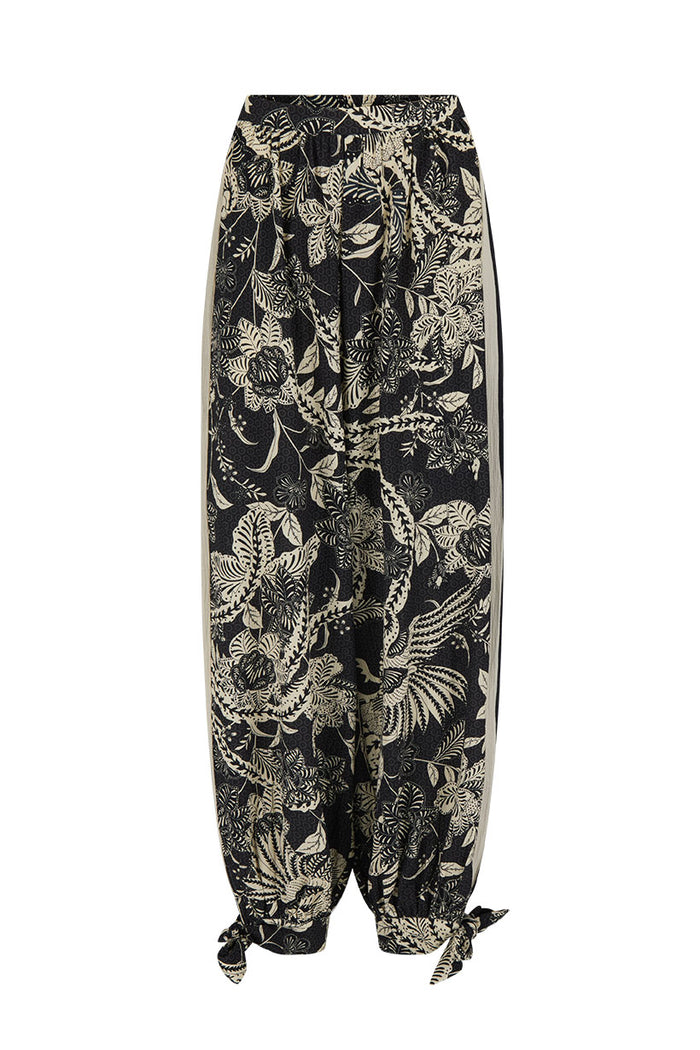 Front flat lay of Volcano Goddess Harem Pant in Liquorice, showing allover print, side stripe, and tie hem cuffs
