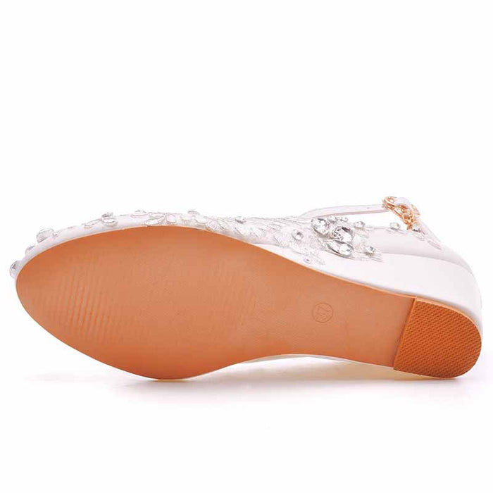 Bottom view of Crystal Queen white wedge bridal sandals featuring beaded embellishments and a comfortable sole
