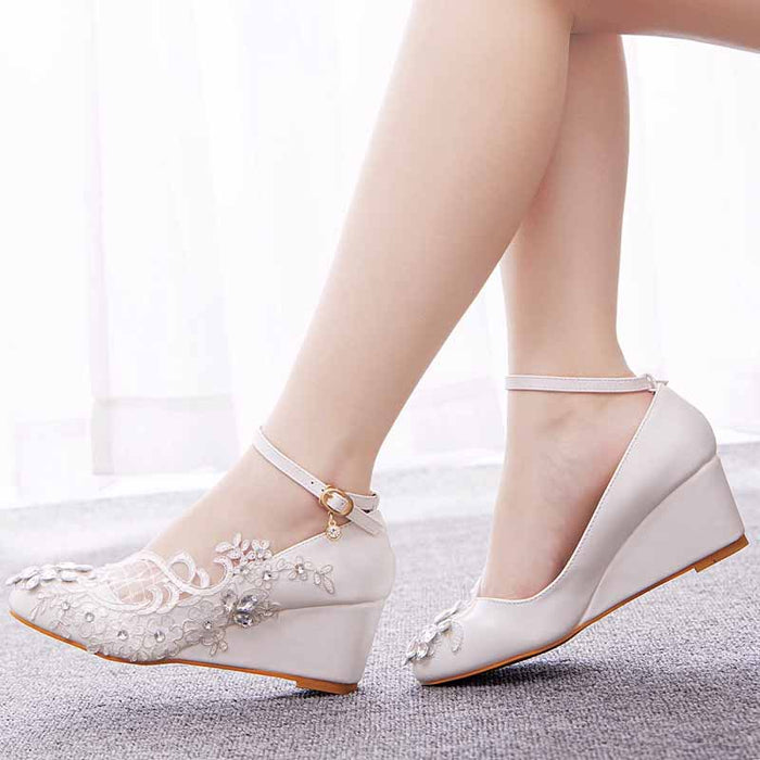 Elegant white wedge bridal sandals with delicate floral embroidery and ankle strap for weddings
