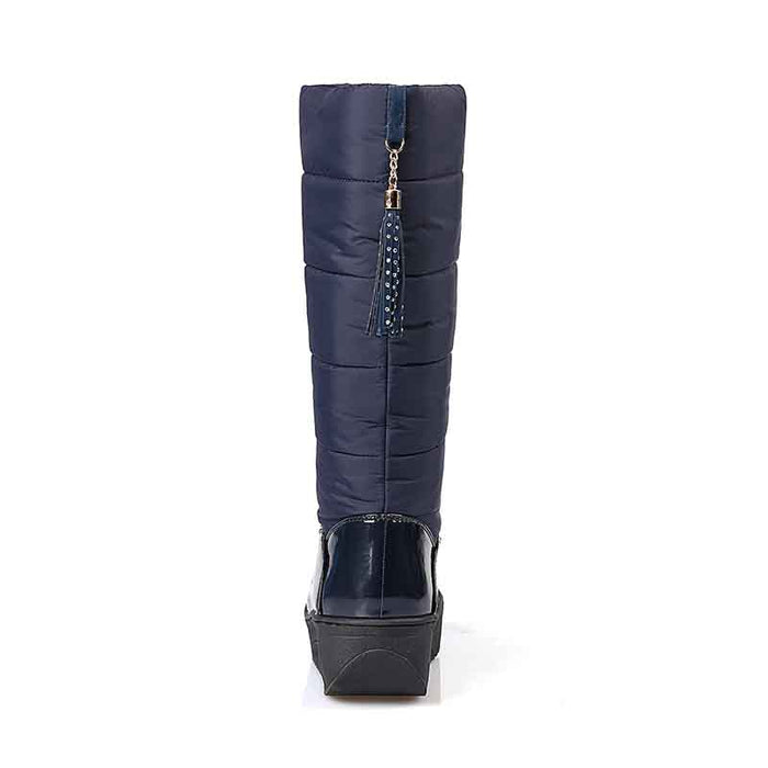Rear view of women's waterproof snow boots with puffy design and tassel accent for winter style