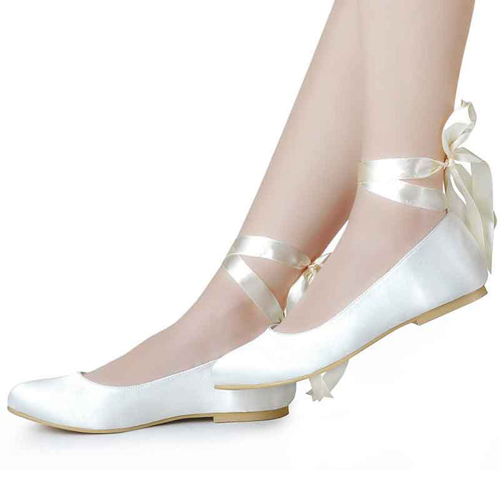 Elegant women's bridal satin flats with delicate ankle ribbons for a stylish wedding day look