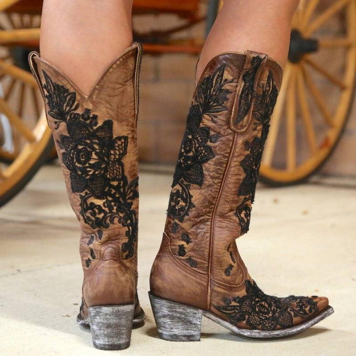 Women's embroidered cowboy boots featuring intricate floral designs and a stylish vintage finish