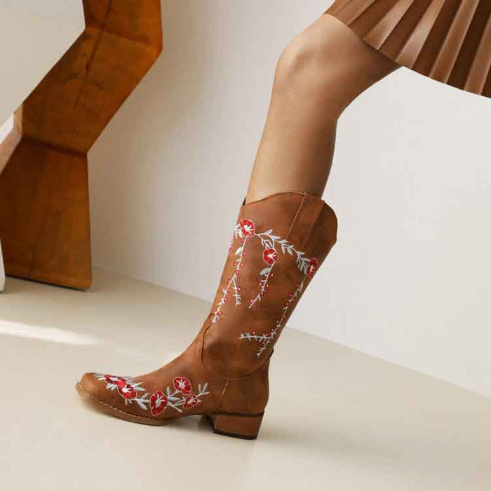 Women's embroidered cowgirl boots with elegant floral design and a stylish heel