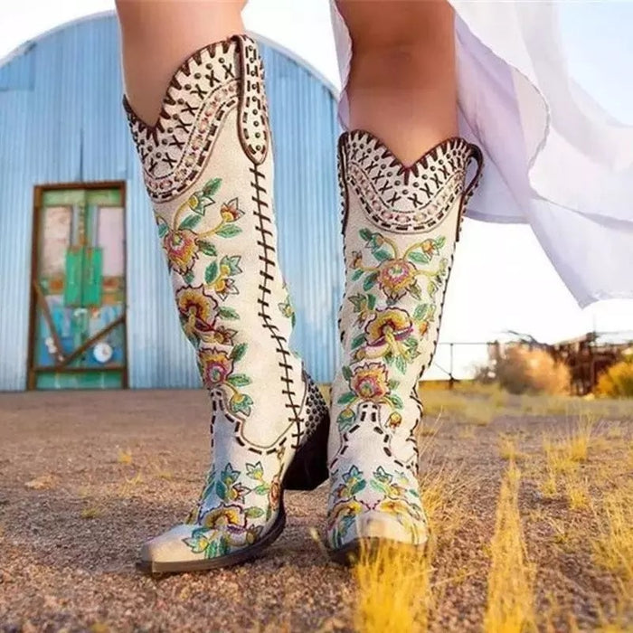 Stylish women's embroidered western cowboy boots with colorful floral designs for trendy outfits
