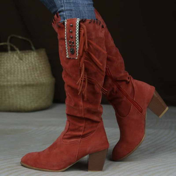 Stylish women's knee high cowgirl boots in red with fringe and decorative studs