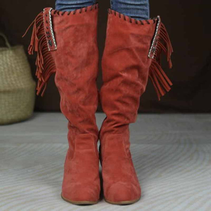 Stylish women's knee high cowgirl boots in red with fringe and decorative hardware for a trendy look