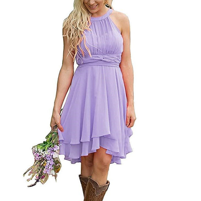 Lavender knee length country bridesmaid dress with halter neck and flowy skirt paired with brown cowboy boots