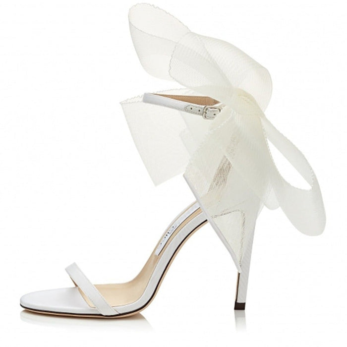 Women's lace up stiletto party sandals in white with a stylish bow detail
