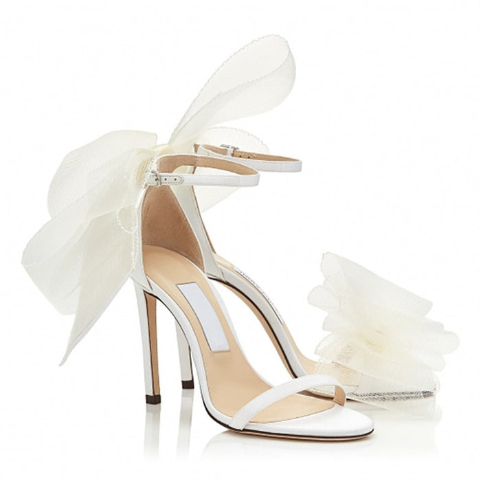 Women's lace up stiletto party sandals in white with elegant bow detail for special occasions