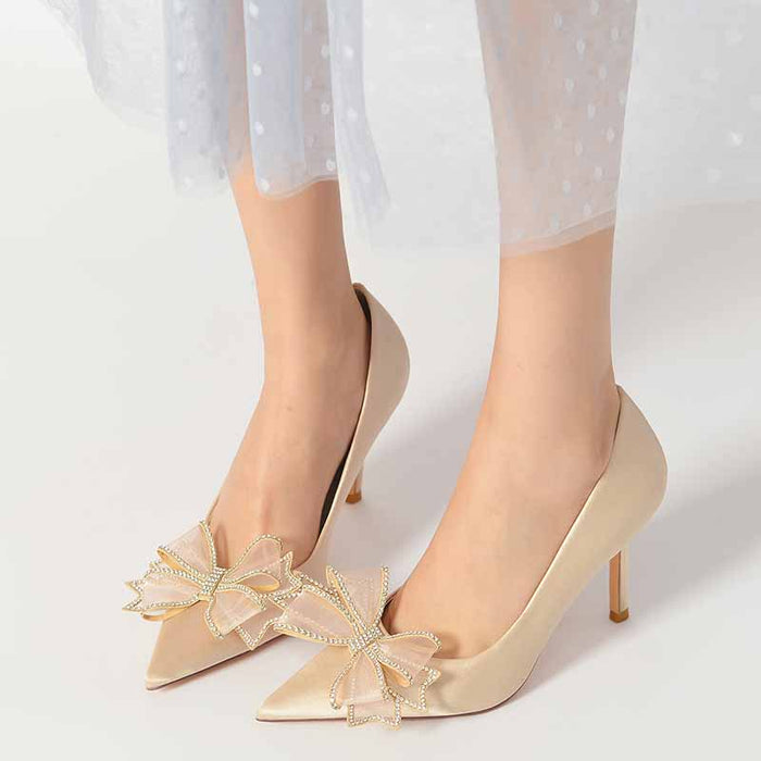 Elegant women's satin wedding shoes with embellished bow details and pointed toe design