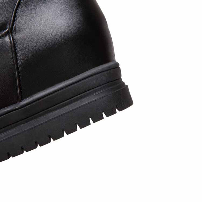 Close-up of women's winter knee high boots with durable rubber sole for cold weather comfort